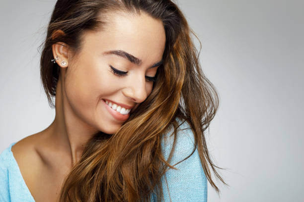 Picture of a beautiful woman smiling and looking down